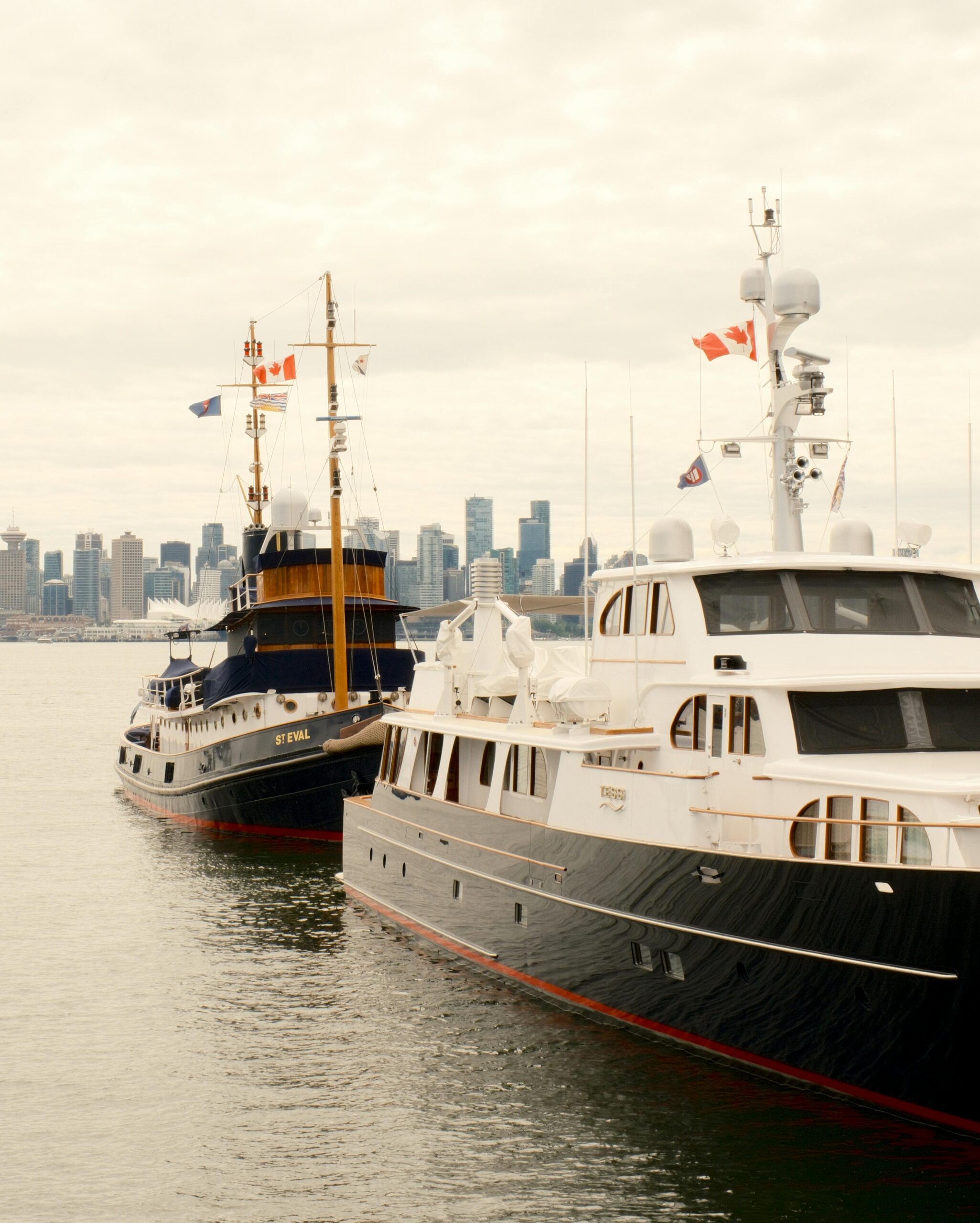 Two boats at a dock with Canadian flags