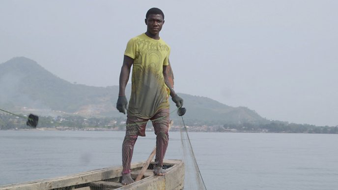 Fisherman on a boat holding a net