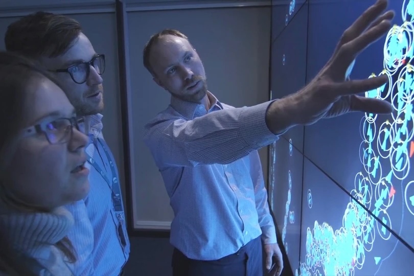 Three people looking at a map