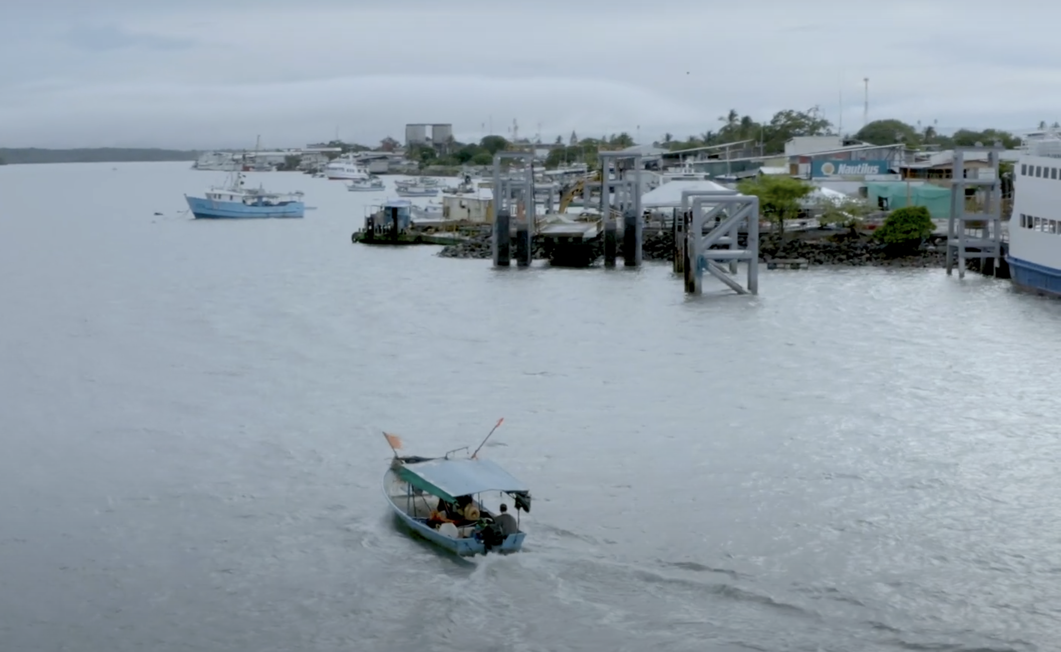 Boast driving by a shipyard