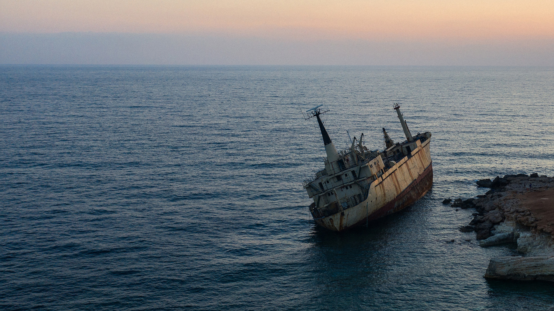 A large ship run aground in the rocks off the coast of Cyprus