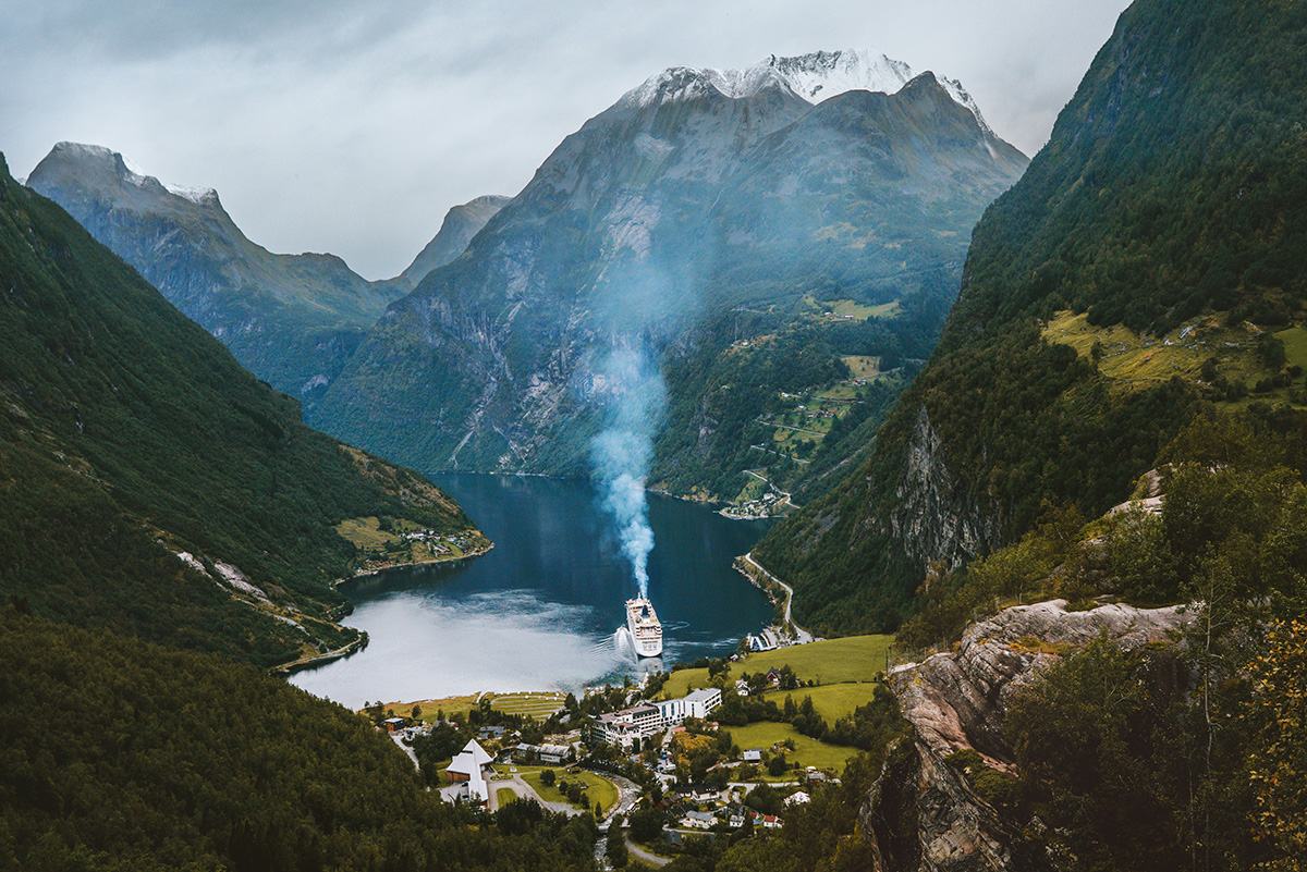 A cruise ship emits pollution into the pristine environment of Norway's Geirangerfjord