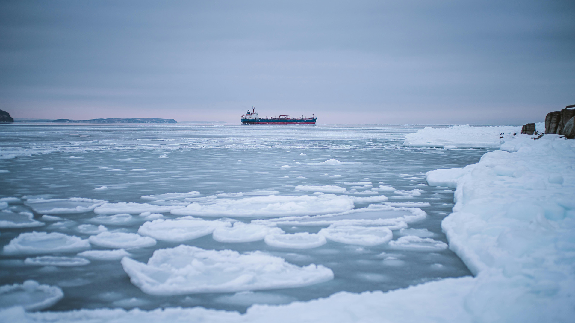 A tanker ship passes through icy Arctic waters