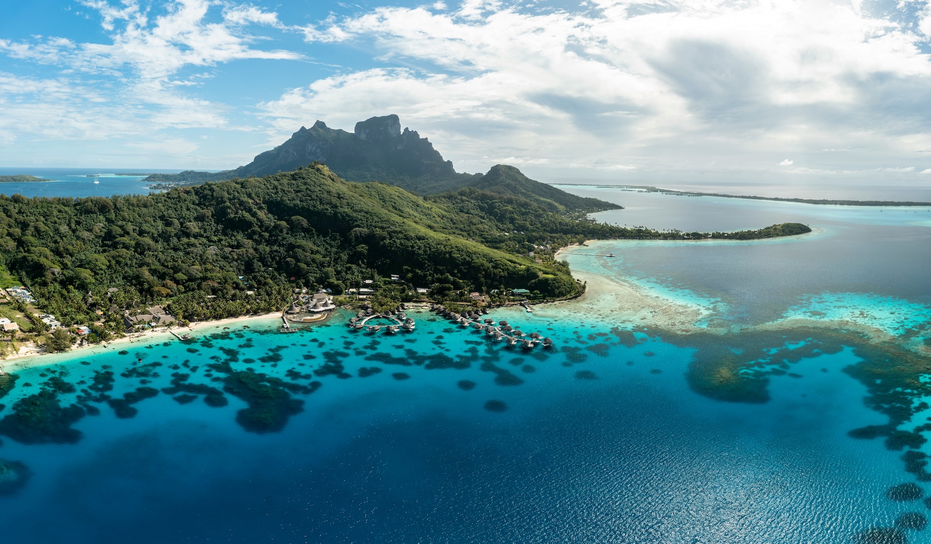 An aerial view of a tropical island in the middle of the ocean in Bora Bora, French Polynesia