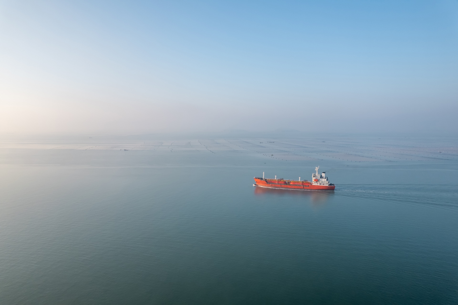 A bird's-eye view of an oil tanker traveling in the sea