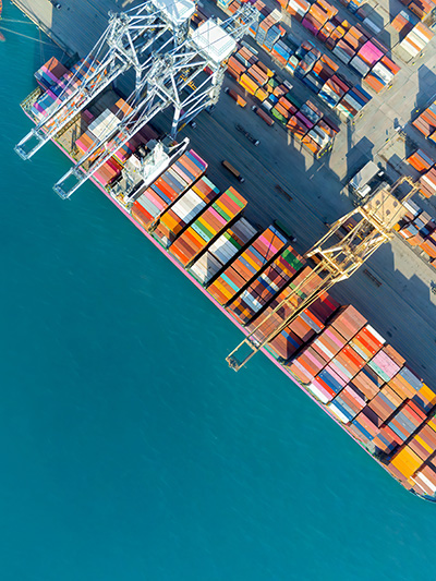 Container ship at port with cranes overhead