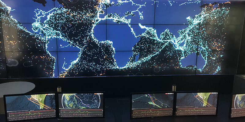 View of computer screens showing ocean ship traffic in an operations control room
